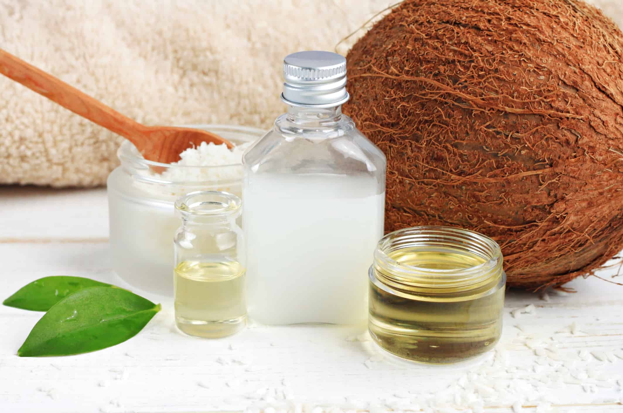 Skincare benefits. Bottles coconut oil, coconut milk, shavings.