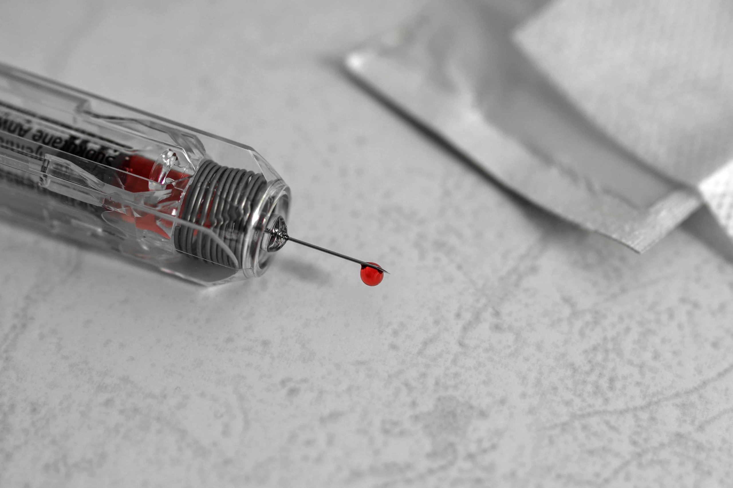 Syringe with drop of blood