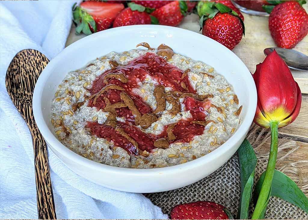 Healing plant-based keto porridge topped with strawberry